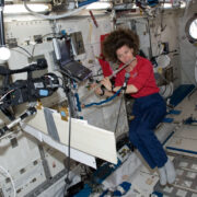 “Cady” Cameron plays the flute on the International Space Station in 2011. Courtesy NASA.
