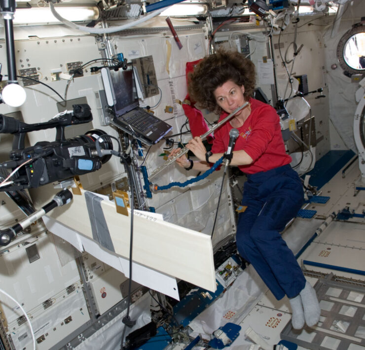 “Cady” Cameron plays the flute on the International Space Station in 2011. Courtesy NASA.